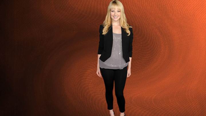 Melissa Rauch Smiling In Black Dress Modeling Pose